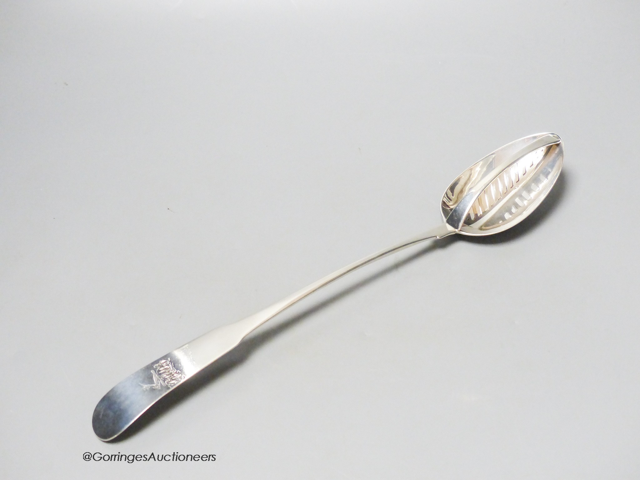 An early George III Irish silver fiddle pattern basting spoon, with strainer, Dublin, 1763, 33.9cm, 4oz.